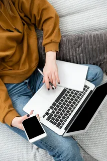 Consumer using a laptop and smartphone